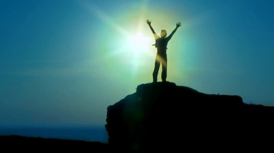 stock-footage-silhouette-man-silhouette-a-man-standing-on-the-edge-of-a-cliff-with-their-hands-up